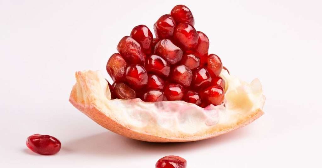 potential risks of dogs eating pomegranate - pomegranate rind that has some seeds on top. 