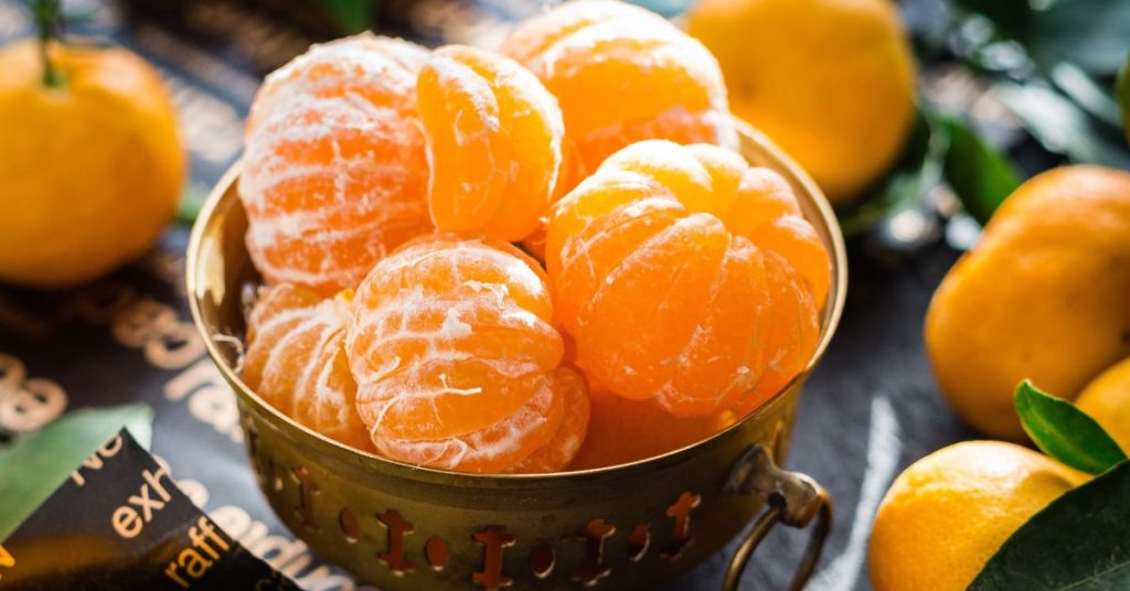 can dogs eat mandarin oranges?  bowl of mandarin oranges on a table. 