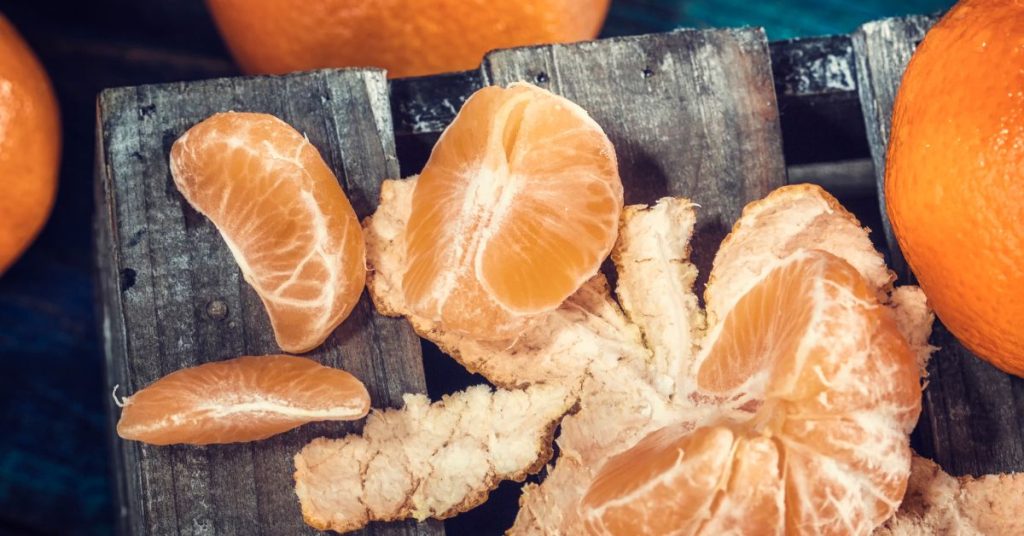 can dogs eat mandarin oranges?  Peeled mandarin oranges on top of a  table.  